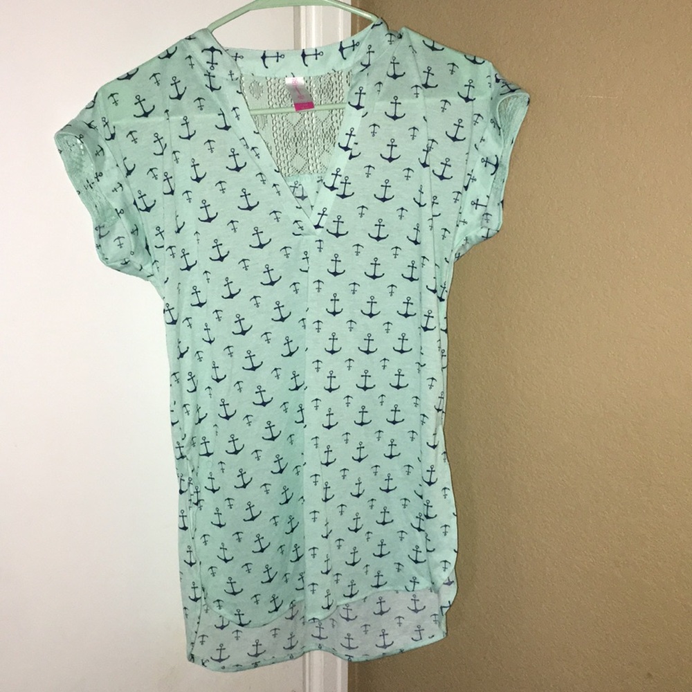 A teal shirt with an anchor design